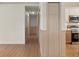 Hallway featuring wood-look flooring, door to the kitchen and stylish wainscoting at 369 Placid Lake Dr, Sanford, FL 32773