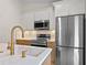 Close-up of the kitchen features stainless steel appliances, white countertops, and custom fixtures at 369 Placid Lake Dr, Sanford, FL 32773