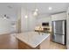 Modern kitchen features stainless steel appliances, island with marbled countertop and pendant lighting at 369 Placid Lake Dr, Sanford, FL 32773