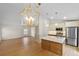 Bright, open kitchen features an island, stainless steel appliances, and stylish light fixtures at 369 Placid Lake Dr, Sanford, FL 32773