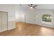 Open-concept living room with hardwood floors, a ceiling fan, and ample natural light at 369 Placid Lake Dr, Sanford, FL 32773