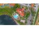 An aerial view of a community pool and clubhouse with lakeside views at 381 Cabello Dr, Davenport, FL 33837