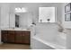 This bathroom features a large tub and a double sink vanity, offering a relaxing and functional space at 381 Cabello Dr, Davenport, FL 33837