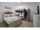 Comfortable bedroom with a queen bed, bunk bed and mounted TV at 381 Cabello Dr, Davenport, FL 33837