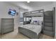 Comfortable bedroom with a gray bunk bed, queen bed and flat screen TV at 381 Cabello Dr, Davenport, FL 33837
