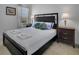 Bright bedroom featuring a black bed, side tables and decorative pillows at 381 Cabello Dr, Davenport, FL 33837