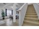 Entryway and staircase leading to upstairs and a view of the formal dining room at 381 Cabello Dr, Davenport, FL 33837