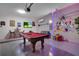 This game room features a pool table, wall art, and a TV for entertainment and relaxation at 381 Cabello Dr, Davenport, FL 33837