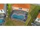 Aerial view of a screened in pool with lounge chairs and table at 381 Cabello Dr, Davenport, FL 33837