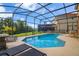 Inviting screened-in pool area with lounge chairs offers a relaxing outdoor space at 381 Cabello Dr, Davenport, FL 33837