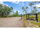 Community sand volleyball court with a covered picnic table and nearby lake at 381 Cabello Dr, Davenport, FL 33837