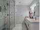 Updated bathroom features a sleek vanity, stylish mirrors, and a luxurious glass shower at 40140 Swift Rd, Eustis, FL 32736