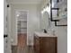 Charming bathroom with wood vanity, modern lighting, and well-placed shelving at 40140 Swift Rd, Eustis, FL 32736