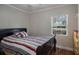 Cozy bedroom with a comfortable bed, natural light from the window, and closet at 40140 Swift Rd, Eustis, FL 32736