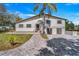 Beautiful two-story home with a large palm tree, brick walkway and spacious driveway at 40140 Swift Rd, Eustis, FL 32736