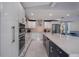 Modern kitchen with large island, stainless steel appliances, and white and dark blue cabinetry at 40140 Swift Rd, Eustis, FL 32736