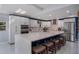 Modern kitchen featuring a large island with seating, stainless steel appliances, and white cabinetry at 40140 Swift Rd, Eustis, FL 32736