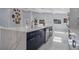 Bright open kitchen with a waterfall edge island, stainless appliances, and white tile flooring at 40140 Swift Rd, Eustis, FL 32736