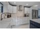 Modern kitchen with white cabinets, marble countertops, stainless steel appliances, and recessed lighting at 40140 Swift Rd, Eustis, FL 32736