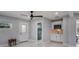 An in-law suite has a kitchenette with bright white cabinets and appliances, with easy access to the shower at 40140 Swift Rd, Eustis, FL 32736