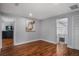 Open living room with gleaming hardwood floors, neutral paint, and easy access to the upstairs at 40140 Swift Rd, Eustis, FL 32736