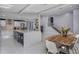 Open-concept living space, connecting kitchen and dining areas with white tile floors and plenty of natural light at 40140 Swift Rd, Eustis, FL 32736
