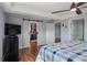 Spacious main bedroom with a walk-in closet, wood floors, and a ceiling fan at 40140 Swift Rd, Eustis, FL 32736