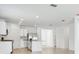 Bright, airy kitchen with white cabinets, stainless steel appliances, and an island with countertop seating at 4709 Jasmine Cir, Leesburg, FL 34748