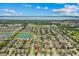 Wide aerial view showing the home's location within a community near a pond and scenic lake backdrop at 5182 Appenine E Loop, St Cloud, FL 34771