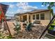 Backyard featuring an outdoor seating area with shade and a built-in fire pit at 5182 Appenine E Loop, St Cloud, FL 34771