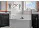 Elegant bathroom with a deep soaking tub and a window, set between dual vanities at 5182 Appenine E Loop, St Cloud, FL 34771