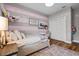 Bright bedroom with stylish decor, wood-look flooring, and ample closet space at 5182 Appenine E Loop, St Cloud, FL 34771