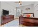 Bright bedroom featuring a ceiling fan, a TV, and a large dresser at 5182 Appenine E Loop, St Cloud, FL 34771
