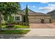Charming home featuring a three-car garage, brick paver driveway, manicured lawn, and well-maintained landscaping at 5182 Appenine E Loop, St Cloud, FL 34771