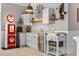 Unique kitchen space featuring decorative vintage elements, white cabinetry, and an adjacent beverage cooler at 5182 Appenine E Loop, St Cloud, FL 34771