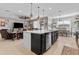 Open kitchen layout with a large center island, stainless steel appliances, and adjacent living and dining areas at 5182 Appenine E Loop, St Cloud, FL 34771