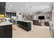 Spacious kitchen with black cabinetry, white countertops, stainless steel appliances, and an open layout to the living room at 5182 Appenine E Loop, St Cloud, FL 34771