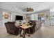 Spacious living area featuring a ceiling fan, leather furniture, and an open flow to the kitchen and outdoor patio at 5182 Appenine E Loop, St Cloud, FL 34771