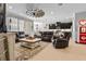 Open living area with leather seating, decorative rug, and stylish lighting, seamlessly connects to the kitchen and dining at 5182 Appenine E Loop, St Cloud, FL 34771