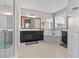 Well-lit bathroom featuring double vanities, a soaking tub, and a glass-enclosed shower at 5182 Appenine E Loop, St Cloud, FL 34771