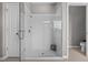 Modern glass-enclosed shower featuring a tile surround, and modern fixtures at 5182 Appenine E Loop, St Cloud, FL 34771