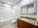 Bathroom featuring a tub and shower combo, decorative mirror, vanity with countertop, and tiled floor at 5431 Lochdale Dr, Orlando, FL 32818