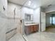 Bathroom featuring a modern shower with glass enclosure, tiled walls, a vanity, and an open doorway at 5431 Lochdale Dr, Orlando, FL 32818