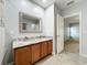 Bright bathroom features double sink vanity with granite counters and modern fixtures, along with an open doorway at 5431 Lochdale Dr, Orlando, FL 32818