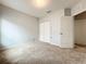 Bedroom featuring a closet with sliding doors, carpeted floor, and neutral color palette at 5431 Lochdale Dr, Orlando, FL 32818