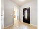 Spacious front entry with tile flooring, archway leading to the kitchen, and a view of the decorative front door at 5431 Lochdale Dr, Orlando, FL 32818