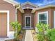 Inviting front entrance with a decorative door, manicured landscaping, and a walkway leading to the home at 5431 Lochdale Dr, Orlando, FL 32818