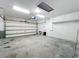 Spacious two-car garage with white concrete block walls and a roll-up door at 5431 Lochdale Dr, Orlando, FL 32818