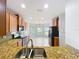 View of kitchen area with granite countertops, tile backsplash, and stainless steel appliances at 5431 Lochdale Dr, Orlando, FL 32818