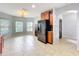 Open kitchen and breakfast nook area features tile floors, black appliances and stylish light fixture at 5431 Lochdale Dr, Orlando, FL 32818